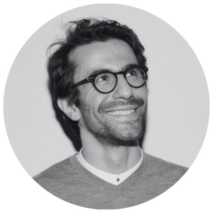 Black and white circular portrait of a man with glasses and a beard. Ali Ganjavian CEO and Co-Founder of Moggie Cat Tracker